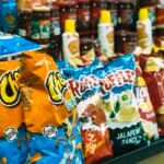 Rows of potato chip bags on display in a grocery store