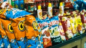 Rows of potato chip bags on display in a grocery store