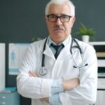 Experienced doctor with a stethoscope in a clinic office