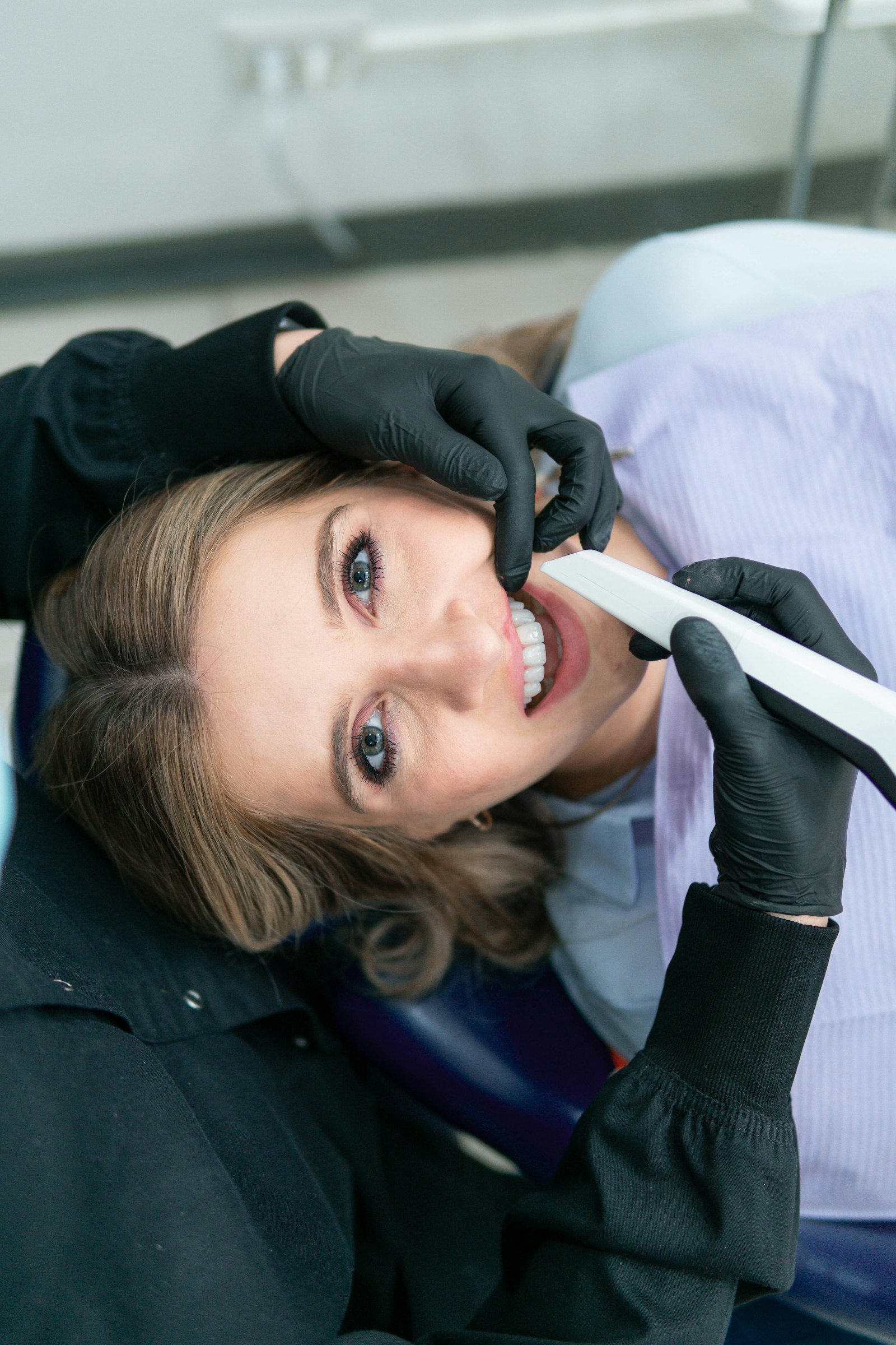Smiling woman holding a toothbrush, representing healthy gums