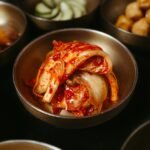 Table topped with bowls of kimchi and other fermented side dishes