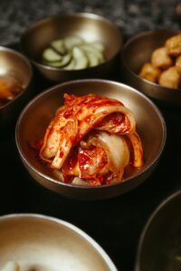 Table topped with bowls of kimchi and other fermented side dishes