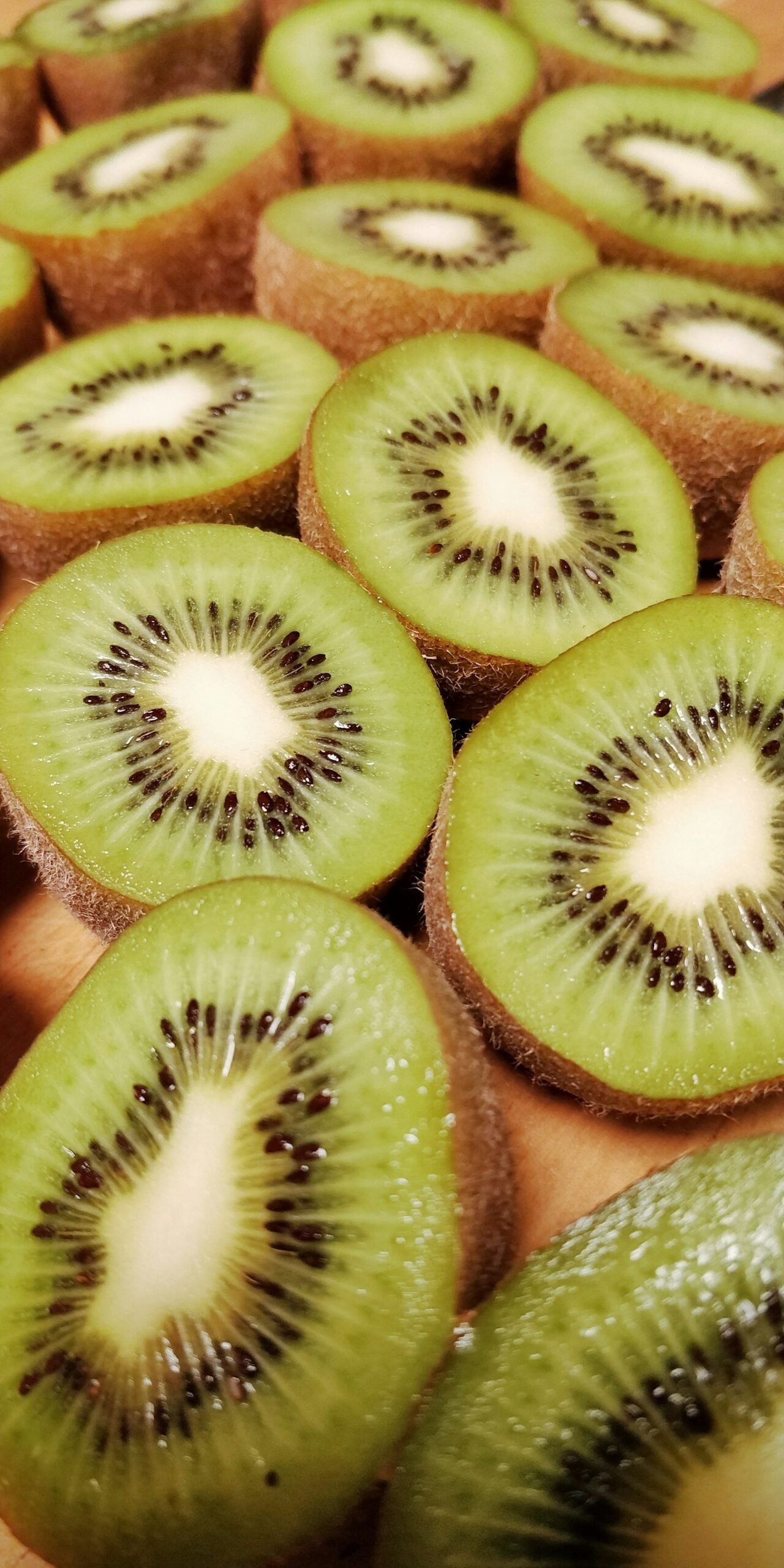 Kiwi cut in half on a wooden cutting board