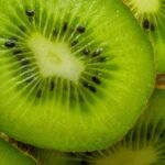 Close-up of a kiwifruit sliced in half, a food rich in vitamin C for skin collagen