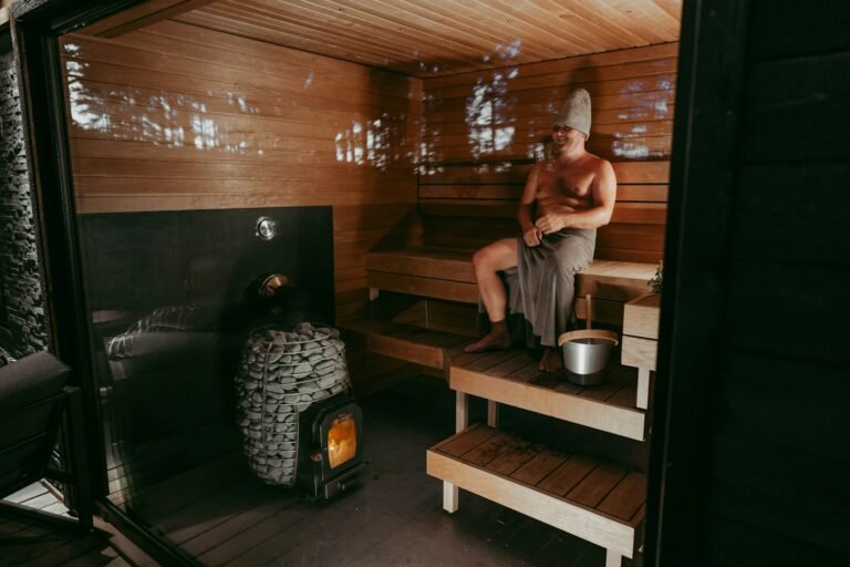 Man sitting on a bench inside a traditional wooden sauna