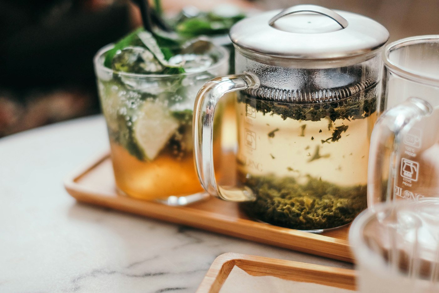 Glass mug of fresh mint tea on a tray