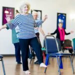 Group of older women dancing together in a room