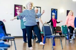 Group of older women dancing together in a room