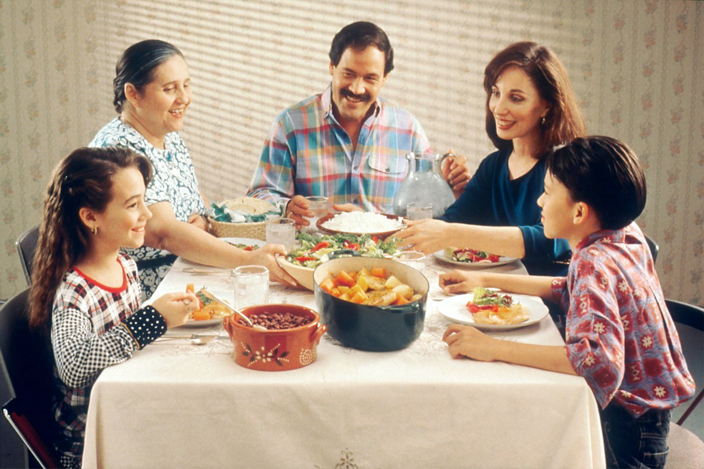 Group of people eating a meal together indoors