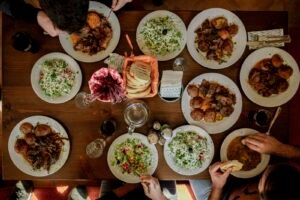 White plates with assorted fresh, colorful foods on a table