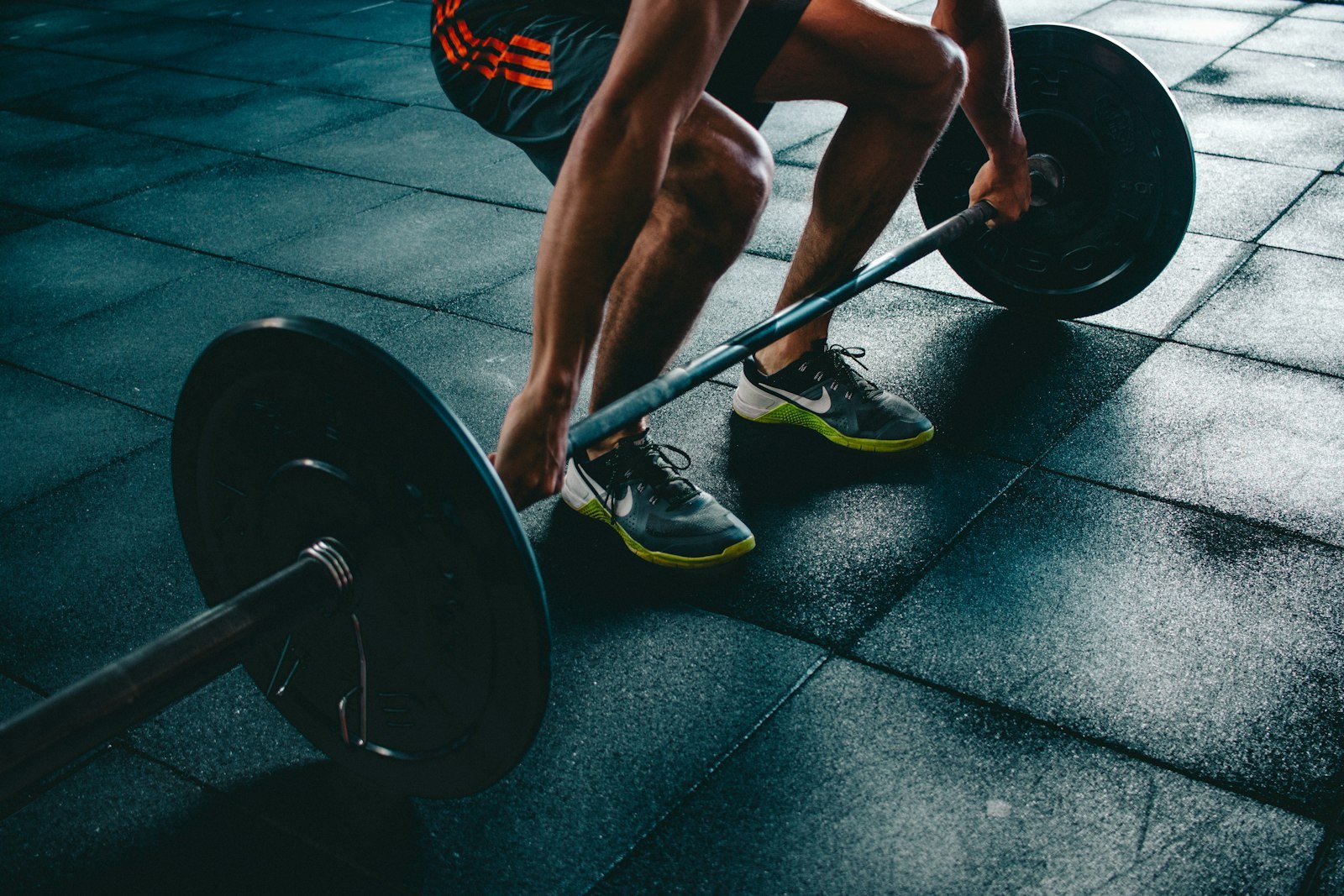 Person gripping a barbell before a heavy lift in the gym