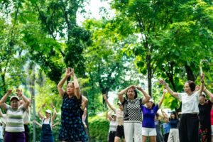 Group of older adults practicing gentle exercise together outdoors in a park