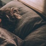 Woman sleeping peacefully under blankets
