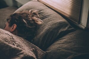 Woman sleeping peacefully under blankets